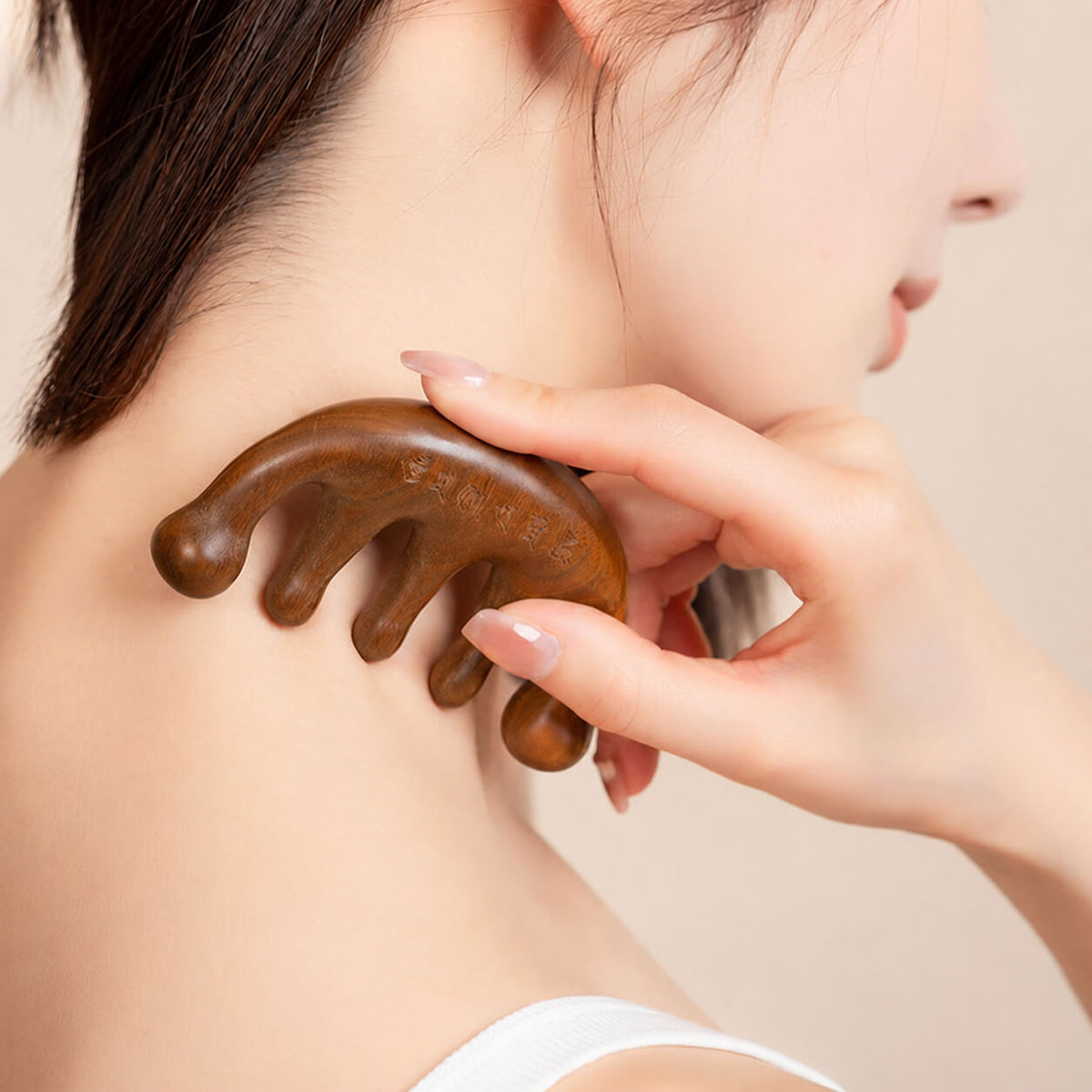 Sandalwood massage comb with traditional Chinese packaging and patterned pouch, presented as a handcrafted scalp massage and relaxation tool on a warm beige background.